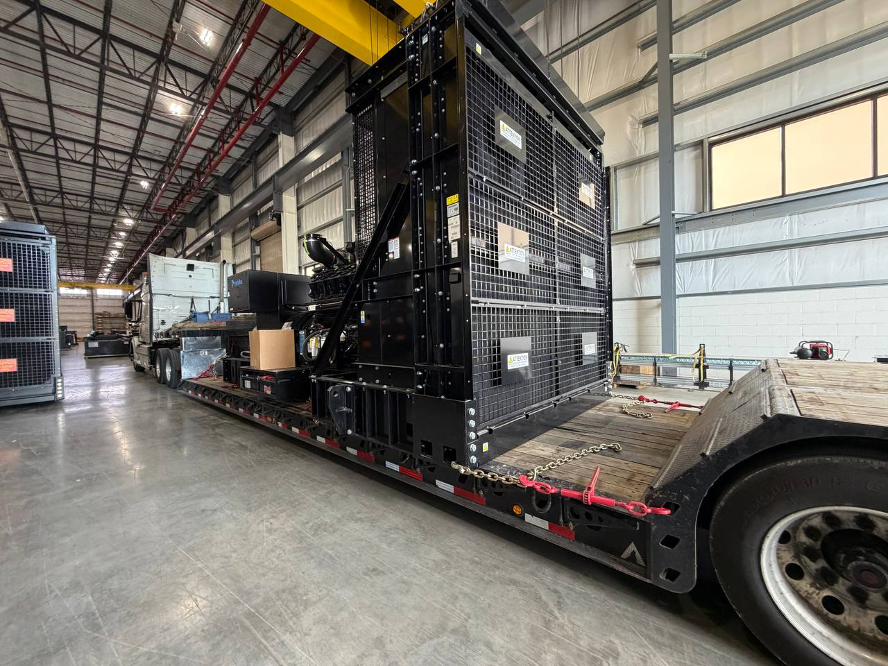 Industrial machinery secured on a flatbed trailer